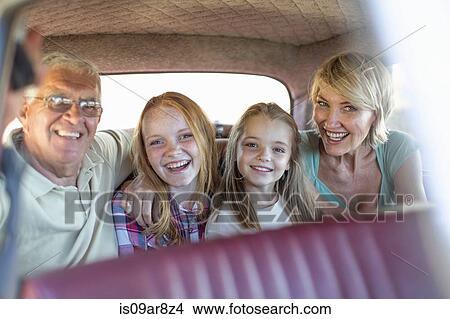 Grandparents and grandchildren sitting in back seat of car, smiling View Large Photo Image Picture - Grandparents and grandchildren sitting in back seat of car, smiling. Fotosearch