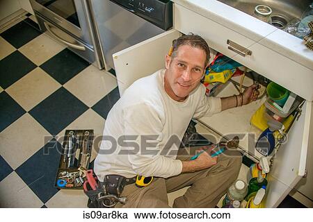 Handyman fixing kitchen sink pipe View Large Photo Image Stock Image - Handyman fixing kitchen sink pipe. Fotosearch