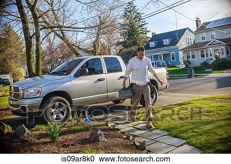 Stock Image - Handyman going to house call. Fotosearch