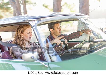 Heterosexual couple in car together, looking lost View Large Photo Image Stock Photograph - Heterosexual couple in car together, looking lost. Fotosearch