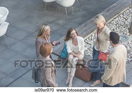 High angle view of businessman and women talking on hotel terrace View Large Photo Image Stock Image - High angle view of businessman and women talking on hotel terrace. Fotosearch