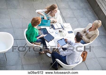 High angle view of businessman and women meeting on hotel terrace View Large Photo Image Stock Image - High angle view of businessman and women meeting on hotel terrace. Fotosearch