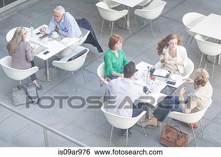 High angle view of businessmen and businesswomen having lunch meetings on hotel terrace View Large Photo Image Stock Photograph - High angle view of businessmen and businesswomen having lunch meetings on hotel terrace. Fotosearch