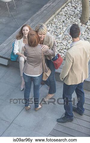 High angle view of businesswomen hugging on hotel terrace View Large Photo Image Stock Photo - High angle view of businesswomen hugging on hotel terrace. Fotosearch