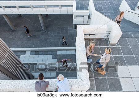 High angle view of elevated walkway, people standing talking View Large Photo Image Stock Image - High angle view of elevated walkway, people standing talking. Fotosearch
