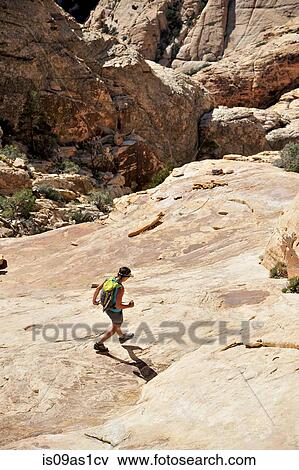 High angle view of young female hiker hiking on rock, Mount Wilson, Nevada, USA View Large Photo Image Stock Photo - High angle view of young female hiker hiking on rock, Mount Wilson, Nevada, USA. Fotosearch