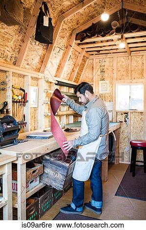 Leather craftsman selecting red leather from box in workshop View Large Photo Image Stock Image - Leather craftsman selecting red leather from box in workshop. Fotosearch