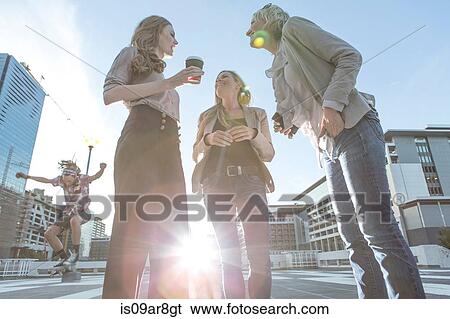 Low angle view of adult women standing talking View Large Photo Image Stock Photograph - Low angle view of adult women standing talking. Fotosearch