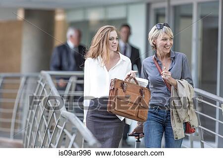 Male and female business team leaving hotel View Large Photo Image Stock Photograph - Male and female business team leaving hotel. Fotosearch