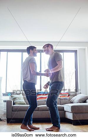 Male couple at home, dancing together, face to face View Large Photo Image Picture - Male couple at home, dancing together, face to face. Fotosearch