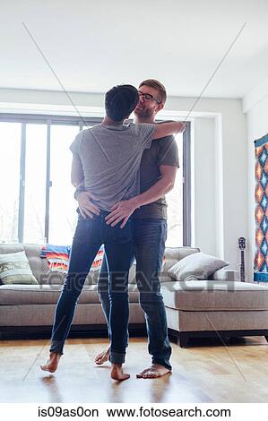 Male couple at home, dancing together, face to face View Large Photo Image Picture - Male couple at home, dancing together, face to face. Fotosearch