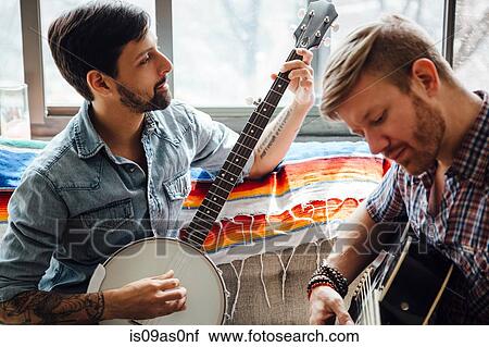 Male couple at home, play guitar and banjo View Large Photo Image Stock Image - Male couple at home, play guitar and banjo. Fotosearch