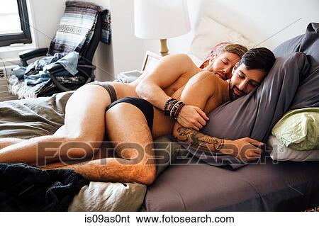 Male couple, partially dressed, lying together on bed, sleeping View Large Photo Image Stock Photograph - Male couple, partially dressed, lying together on bed, sleeping. Fotosearch