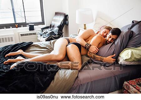 Male couple, partially dressed, lying together on bed, sleeping View Large Photo Image Stock Photograph - Male couple, partially dressed, lying together on bed, sleeping. Fotosearch