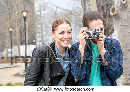 Man taking photograph in park, New York, New York, USA View Large Photo Image Stock Image - Man taking photograph in park, New York, New York, USA. Fotosearch