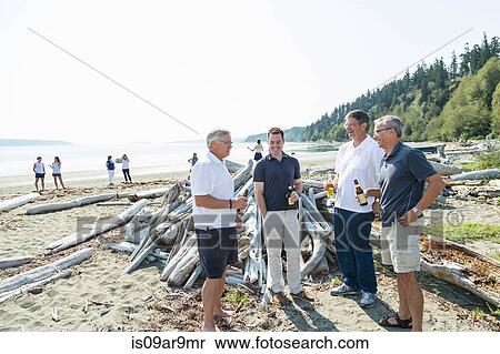Mature brothers and son chatting and drinking beer on beach View Large Photo Image Stock Photography - Mature brothers and son chatting and drinking beer on beach. Fotosearch