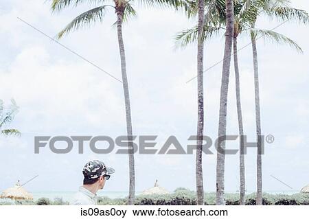 Mid adult man looking at view, Miami Beach, Florida, USA View Large Photo Image Stock Photo - Mid adult man looking at view, Miami Beach, Florida, USA. Fotosearch