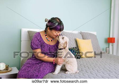 Stock Photography - Mid adult woman nose to nose with dog. Fotosearch