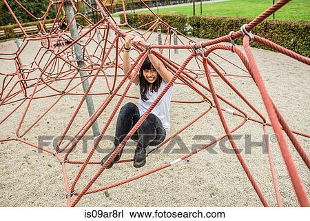 Mid adult woman using climbing ropes, smiling at camera View Large Photo Image Stock Image - Mid adult woman using climbing ropes, smiling at camera. Fotosearch