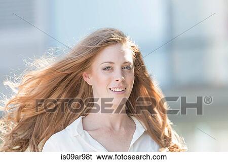 Portrait of beautiful young woman with long red hair View Large Photo Image Stock Photograph - Portrait of beautiful young woman with long red hair. Fotosearch