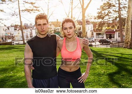 Stock Photography - Portrait of confident young sport couple in park. Fotosearch