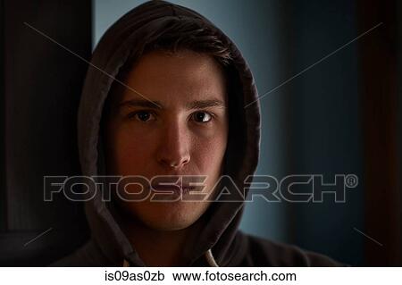Portrait of intimidating young man wearing hood in shadows View Large Photo Image Stock Image - Portrait of intimidating young man wearing hood in shadows. Fotosearch