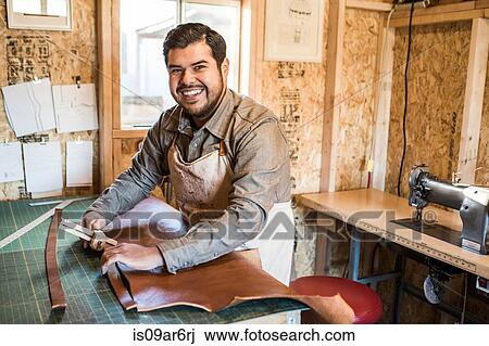 Portrait of leather craftsman at workshop bench View Large Photo Image Stock Image - Portrait of leather craftsman at workshop bench. Fotosearch