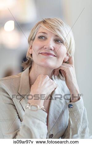 Stock Photo - Portrait of mature businesswoman looking up. Fotosearch