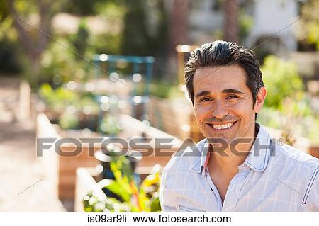 Portrait of mid adult man in community garden View Large Photo Image Stock Image - Portrait of mid adult man in community garden. Fotosearch
