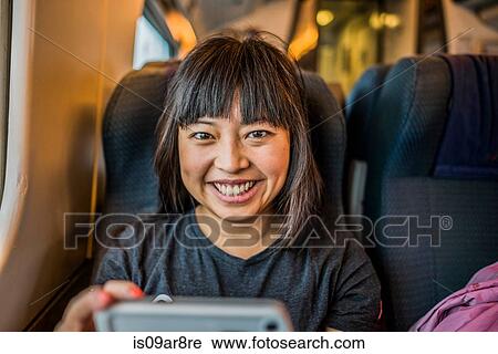 Portrait of mid adult woman on train smiling at camera View Large Photo Image Stock Image - Portrait of mid adult woman on train smiling at camera. Fotosearch