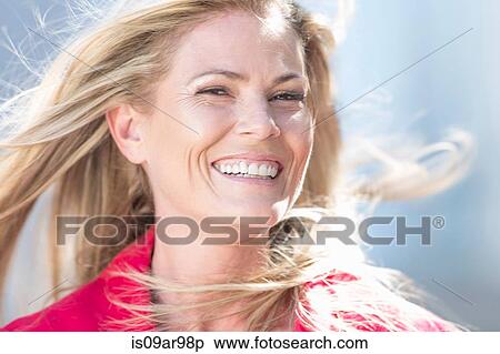 Portrait of mid adult woman with long blond flyaway hair View Large Photo Image Stock Photography - Portrait of mid adult woman with long blond flyaway hair. Fotosearch