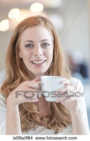 Picture - Portrait of young businesswoman drinking coffee. Fotosearch
