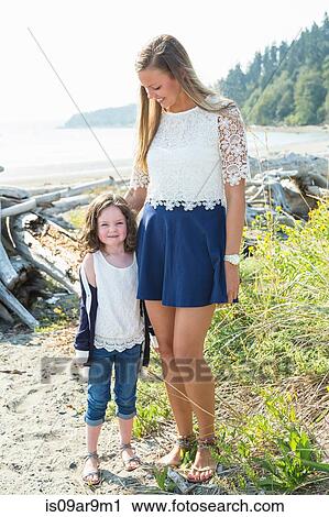 Portrait of young woman and daughter on beach View Large Photo Image Stock Image - Portrait of young woman and daughter on beach. Fotosearch