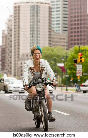 Portrait of young woman with colourful hair, riding motorcycle View Large Photo Image Stock Image - Portrait of young woman with colourful hair, riding motorcycle. Fotosearch