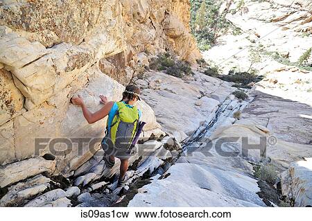 Rear view of young female rock climber climbing down crevice, Mount Wilson, Nevada, USA View Large Photo Image Stock Photo - Rear view of young female rock climber climbing down crevice, Mount Wilson, Nevada, USA. Fotosearch