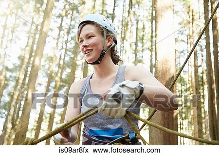 Stock Photo - Rock climber preparing safety harness. Fotosearch
