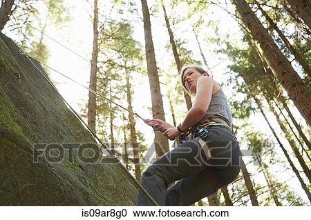 Stock Image - Rock climber scaling rock. Fotosearch