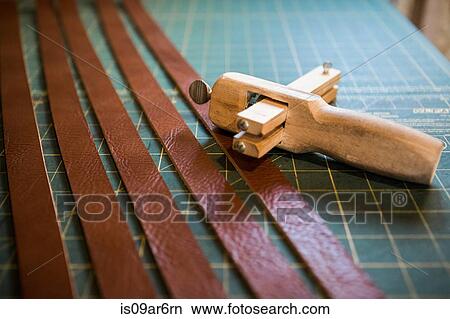 Picture - Row of leather strips on workshop bench. Fotosearch