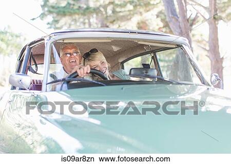 Senior man and mature woman in car together, smiling View Large Photo Image Picture - Senior man and mature woman in car together, smiling. Fotosearch