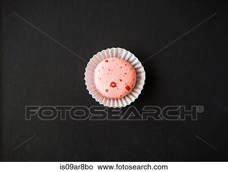Single macaron against black background, overhead view View Large Photo Image Picture - Single macaron against black background, overhead view. Fotosearch