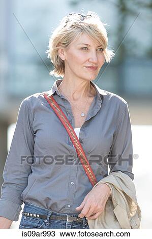 Smiling mature woman leaving hotel View Large Photo Image Stock Image - Smiling mature woman leaving hotel. Fotosearch