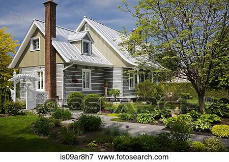 Stacked log home with Amur Maackia tree in front yard at springtime, Quebec, Canada View Large Photo Image Stock Photo - Stacked log home with Amur Maackia tree in front yard at springtime, Quebec, Canada. Fotosearch