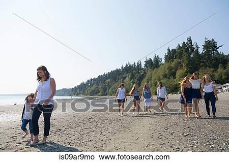 Three generation female family strolling on beach View Large Photo Image Picture - Three generation female family strolling on beach. Fotosearch