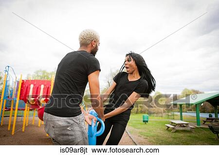 Two young men having fun in playground View Large Photo Image Stock Photograph - Two young men having fun in playground. Fotosearch