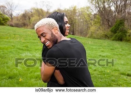 Two young men hugging in park View Large Photo Image Picture - Two young men hugging in park. Fotosearch