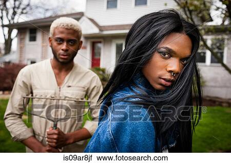 Stock Image - Two young men posing in front yard. Fotosearch