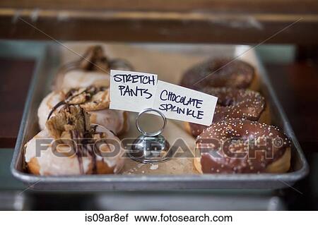 Stock Image - Vegan, allergy-friendly doughnuts on tray. Fotosearch