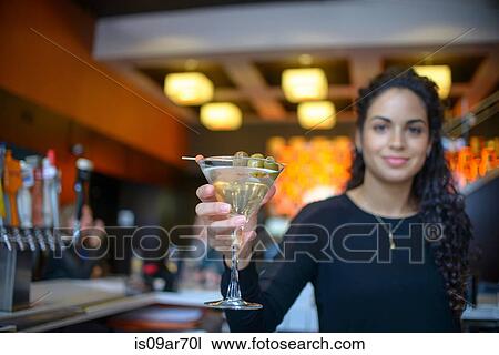 Young female bartender handing cocktail in cocktail bar View Large Photo Image Stock Image - Young female bartender handing cocktail in cocktail bar. Fotosearch