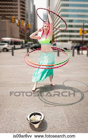 Young female performer hoola hooping on city street, Philadelphia, Pennsylvania, USA View Large Photo Image Stock Photo - Young female performer hoola hooping on city street, Philadelphia, Pennsylvania, USA. Fotosearch