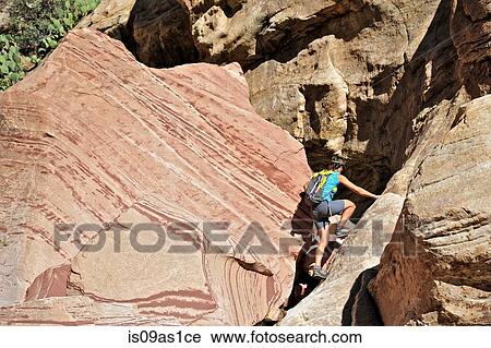 Young female rock climber climbing up Mount Wilson, Nevada, USA View Large Photo Image Stock Image - Young female rock climber climbing up Mount Wilson, Nevada, USA. Fotosearch